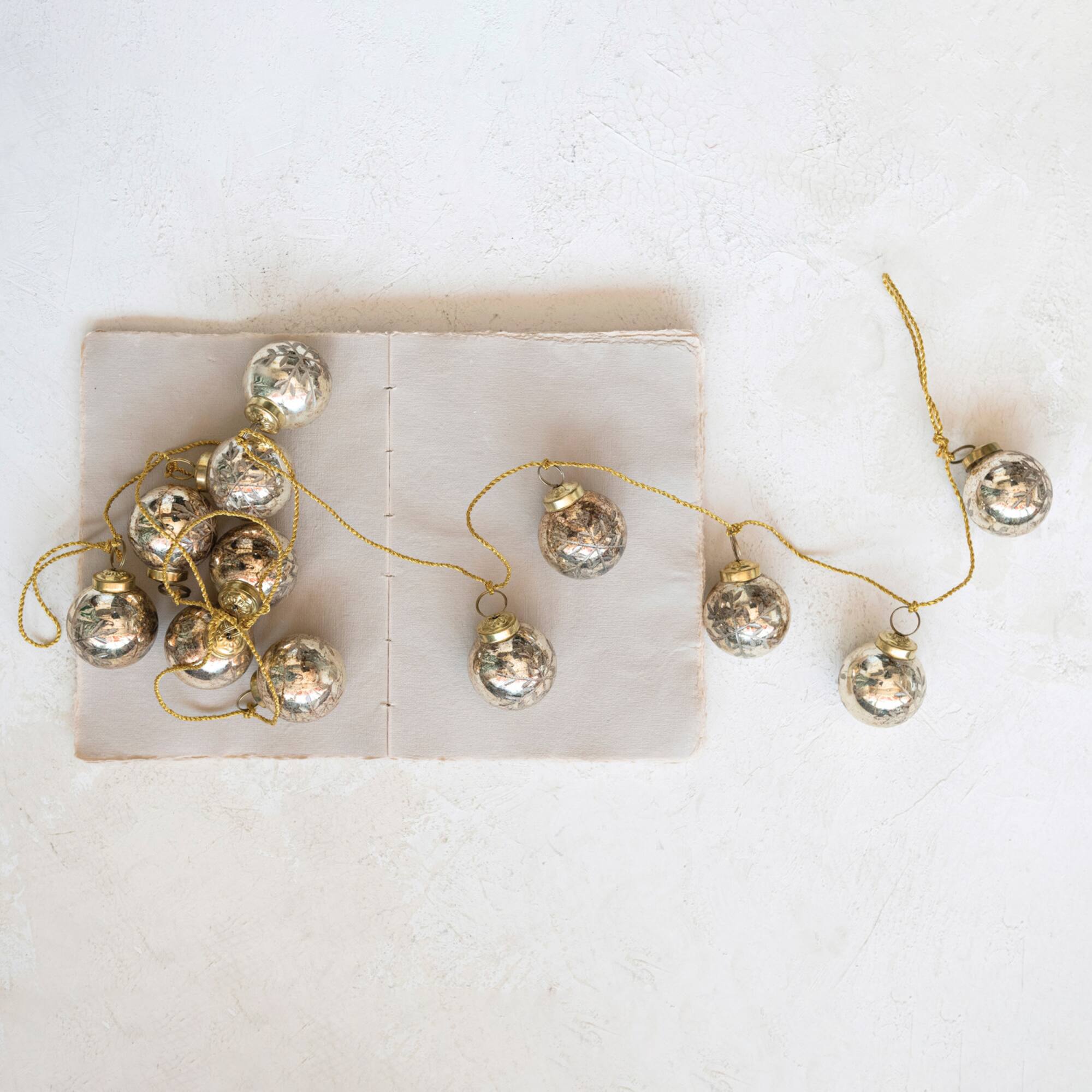 Hello Honey® 6ft. Antique Gold Etched Mercury Glass Ball Ornament Garland with Snowflakes